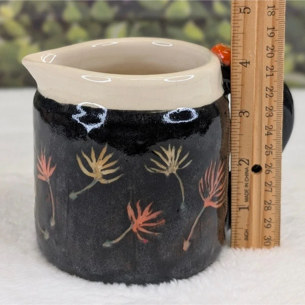Handcrafted Black Ceramic Pitcher with Floral Design